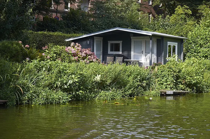 small house water s edge green nature lake based