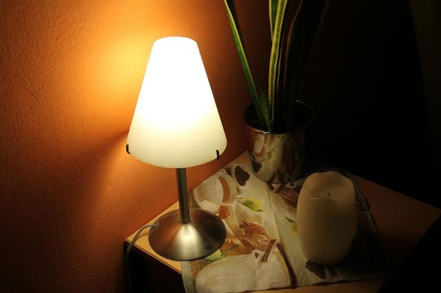 bedside table night table lamp lamp light lighting ambience atmosphere shining