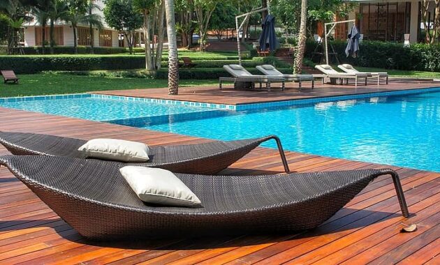 relaxing loungers pool side swimming pool resort thailand luxury vacation summer