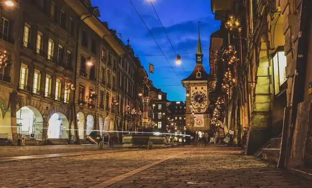 city night tower street pavers paved clock fountain architecture