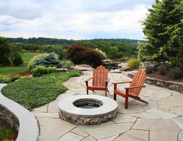 stacked stone fire pit with seating area