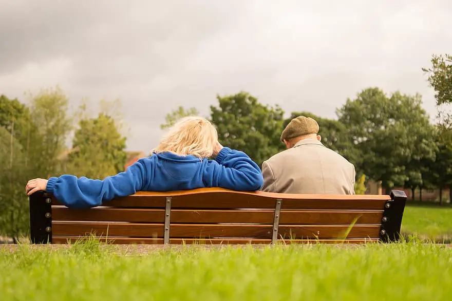 people sitting resting waiting man woman elderly person senior