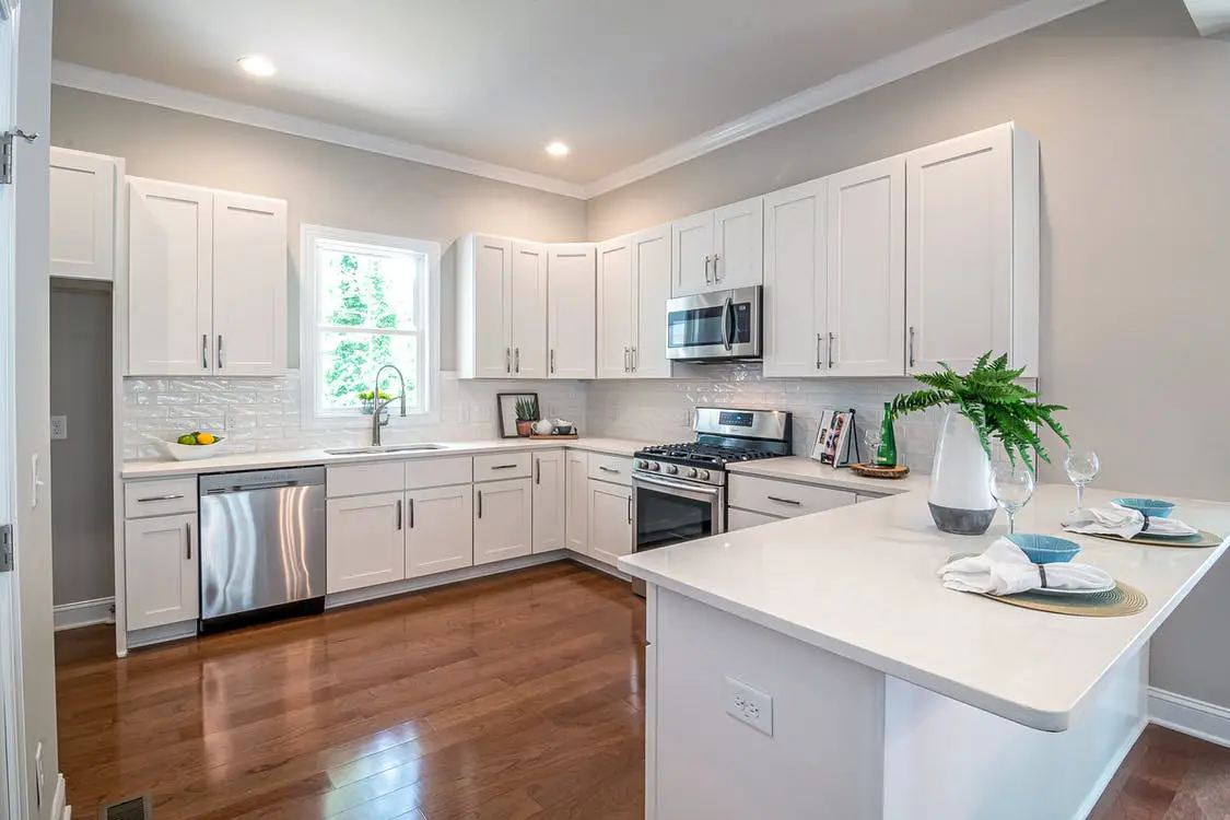 do kitchen cabinets go on top of flooring