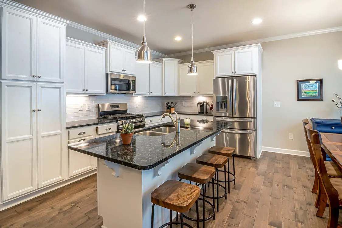 do kitchen cabinets sit on top of flooring