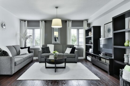 clean white living room with square carpet accent